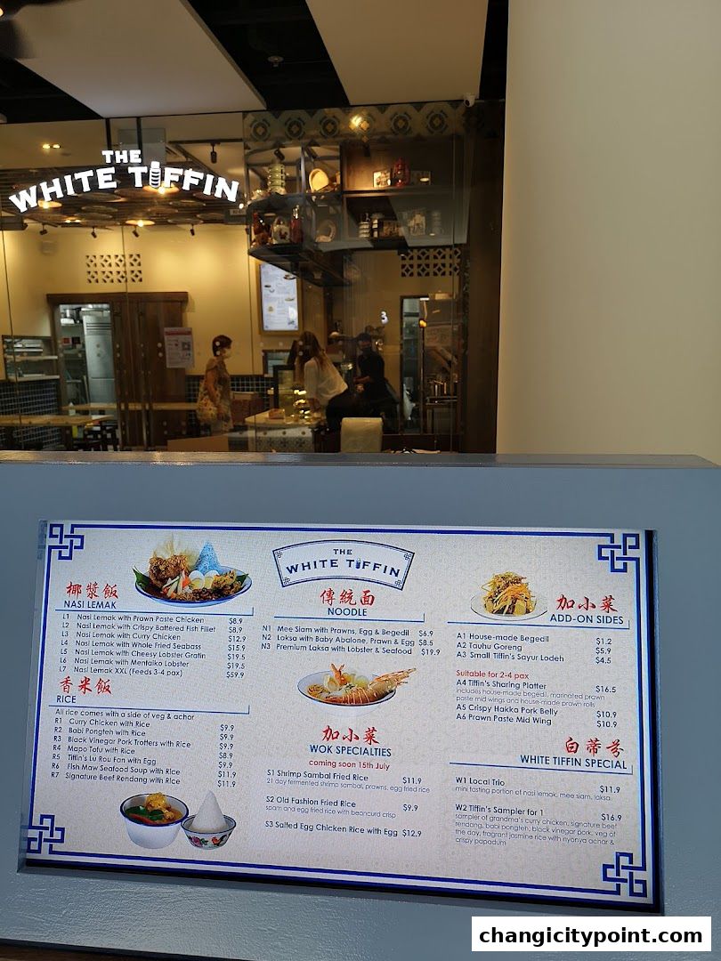 A menu board for The White Tiffin restaurant, showcasing various nasi lemak, rice dishes, noodles, and wok specialties.