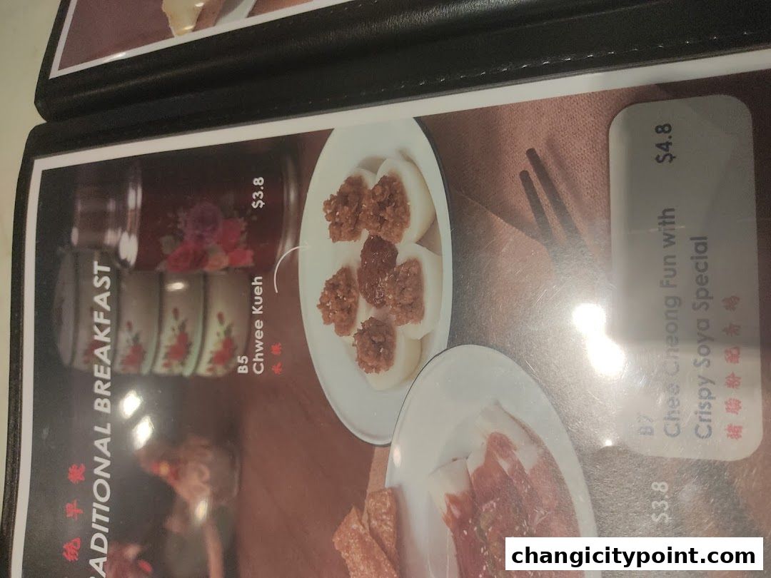A menu page from The White Tiffin featuring traditional breakfast items like Chwee Kueh and Chee Cheong Fun.