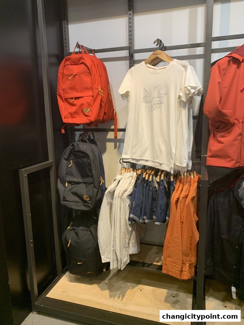 Timberland store display featuring backpacks, t-shirts, shorts, and jackets.
