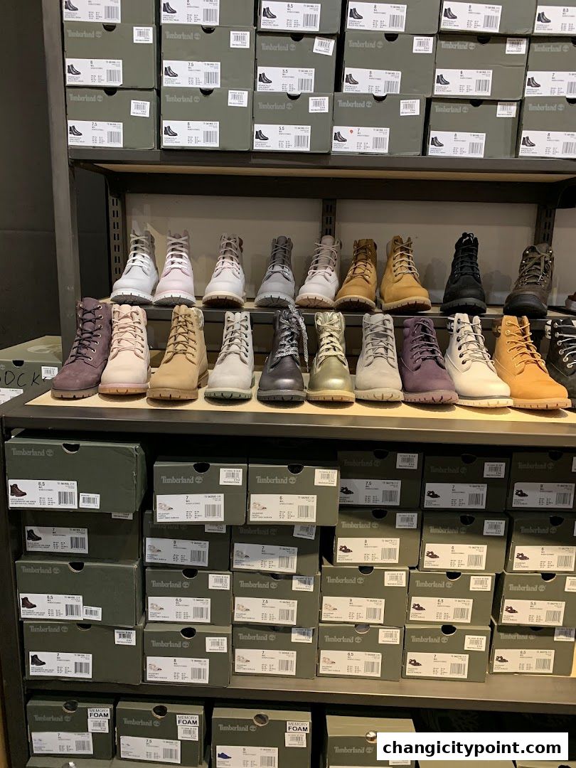 A display of Timberland boots and their boxes stacked on shelves.