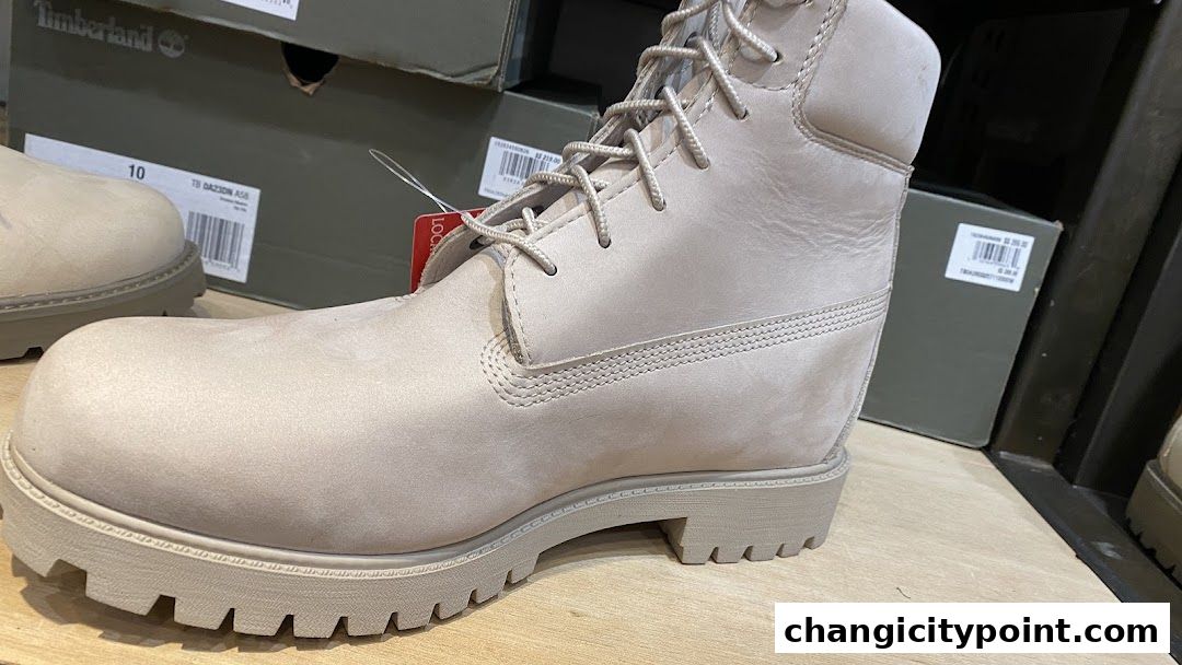 Close-up of a light-colored Timberland boot with boxes in the background.