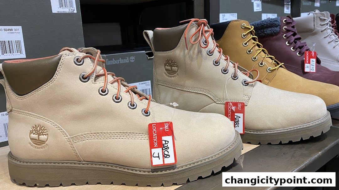 A row of Timberland boots in various colors, displayed on a shelf.