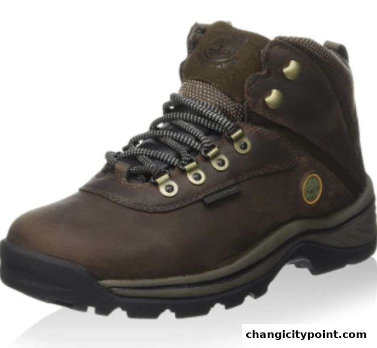 A close-up view of a brown Timberland hiking boot with laces and rugged sole.