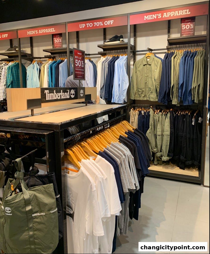 Interior view of a Timberland store showcasing men's apparel and a sale.