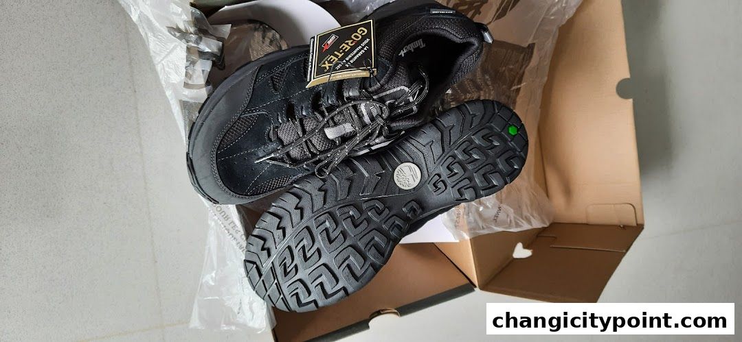 A pair of black Timberland GORE-TEX hiking boots in their box.