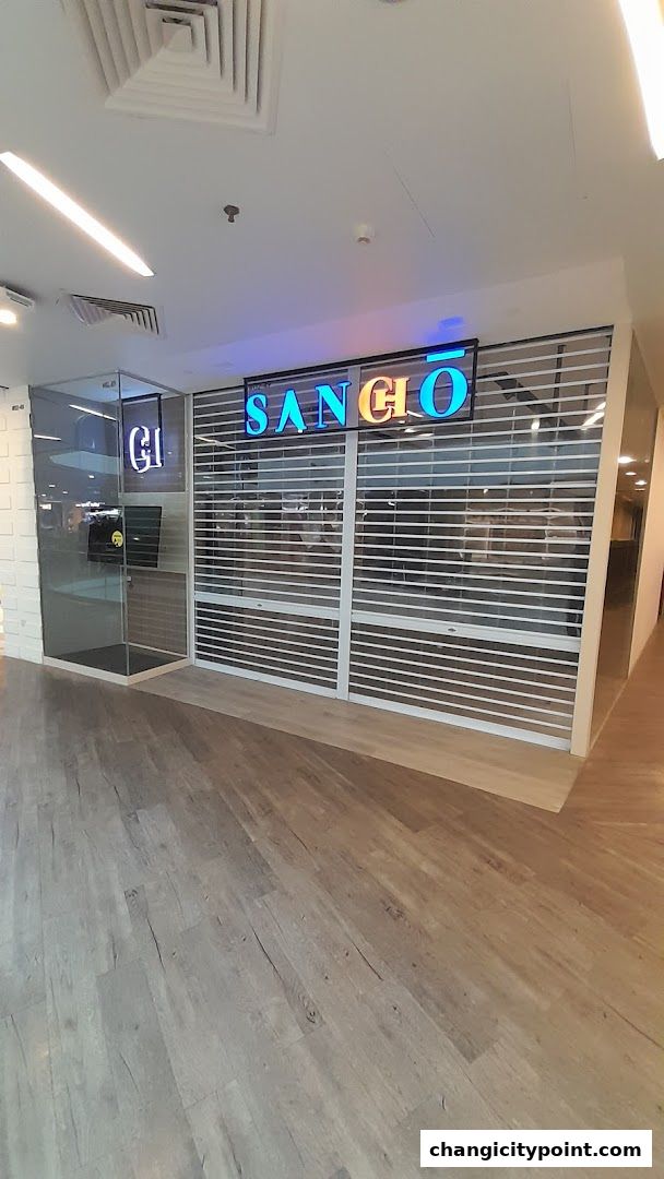 The closed storefront of Sangio, featuring a prominent neon sign and a glass entrance.