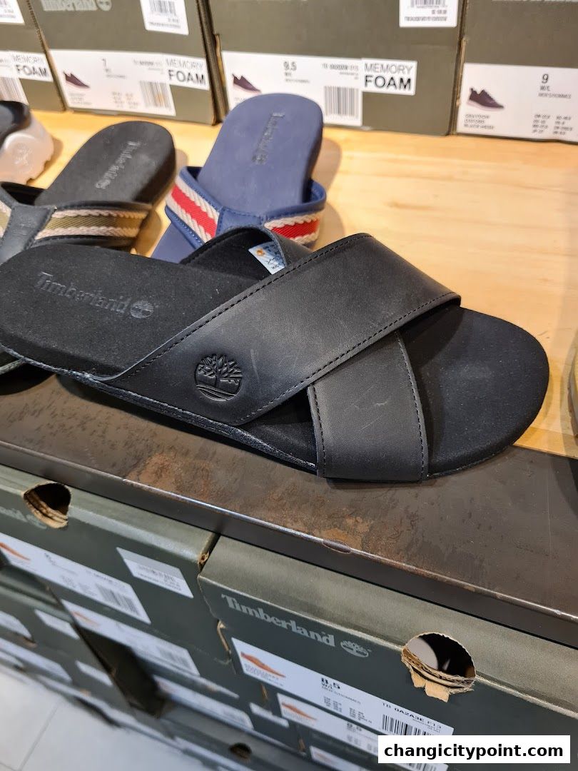 Close-up of Timberland sandals and shoe boxes on display.