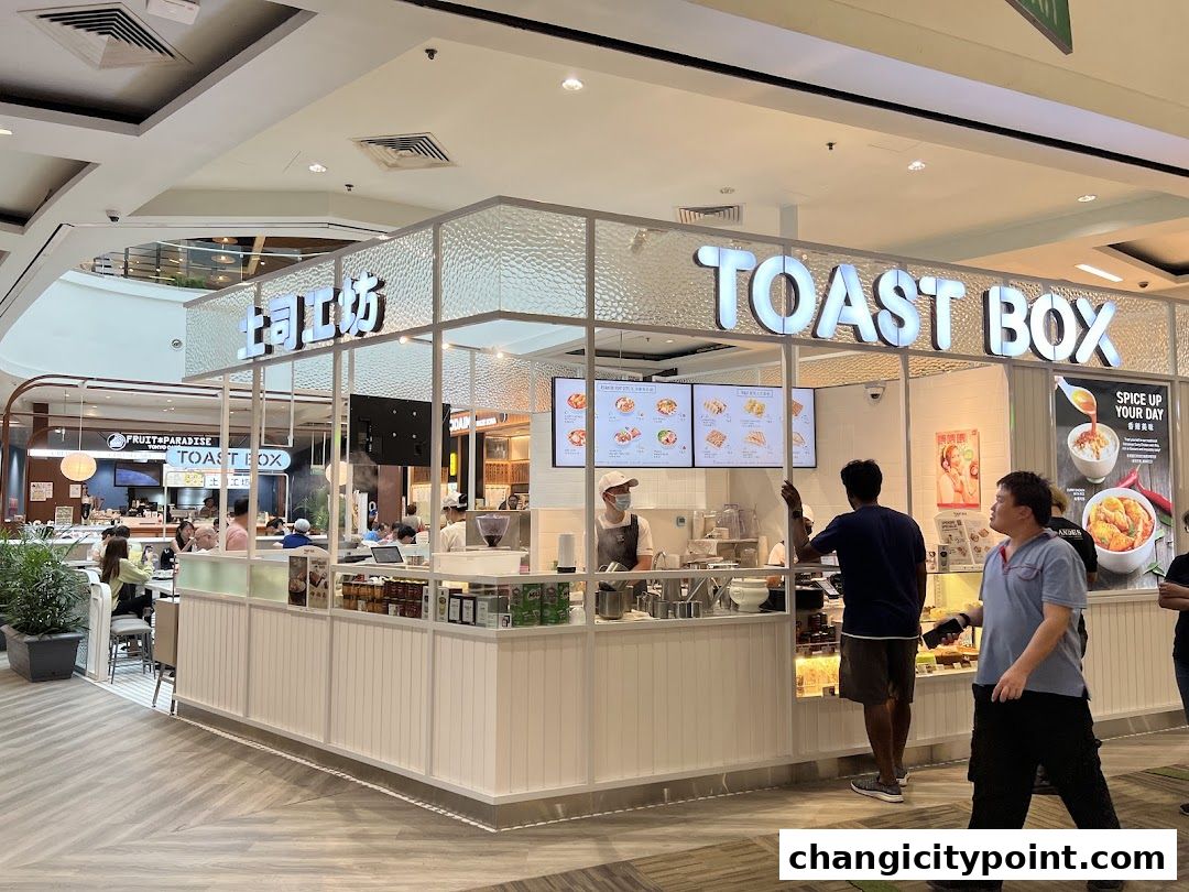 The Toast Box shop front with customers ordering and staff preparing food.