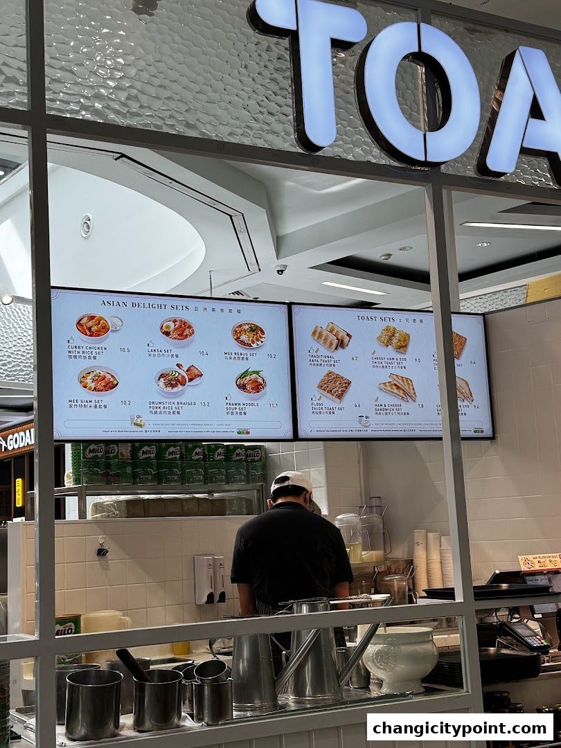 A menu board displays Asian delight sets and toast sets at Toast Box.