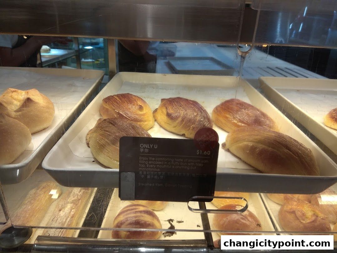 A display of freshly baked buns and pastries at Toast Box Changi City Point.