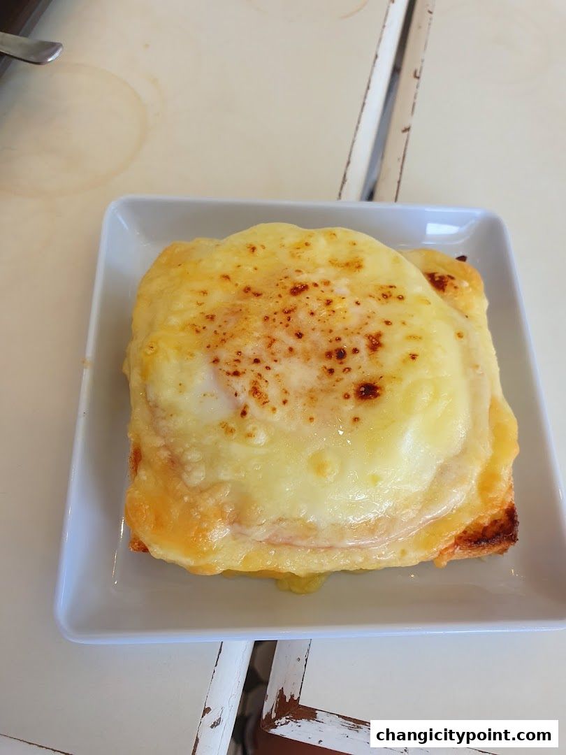 A delicious-looking baked sandwich with melted cheese and a golden-brown crust.