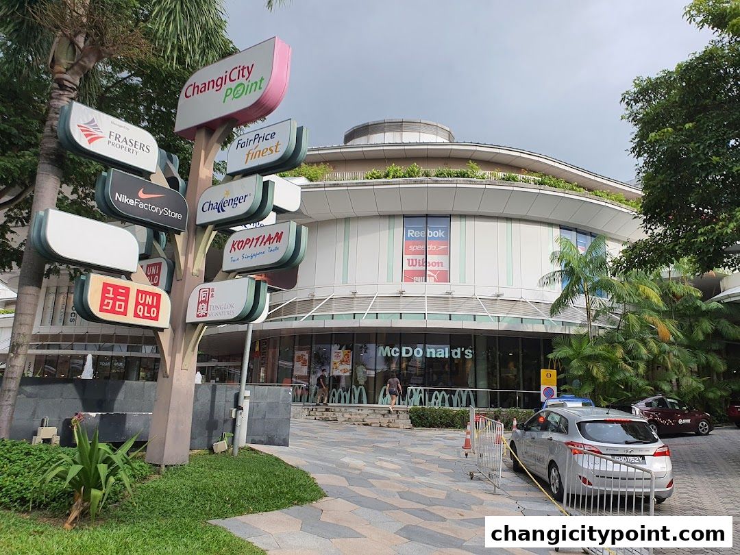 Changi City Point mall entrance with various store signs and McDonald's.