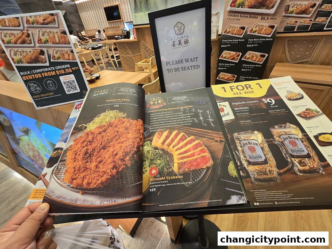 A spread of menus showcasing Japanese tonkatsu dishes and drinks.