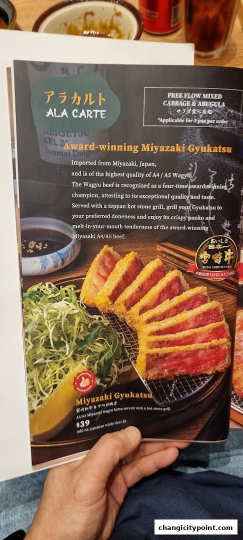 A menu featuring award-winning Miyazaki Gyukatsu served with shredded cabbage and a dipping sauce.