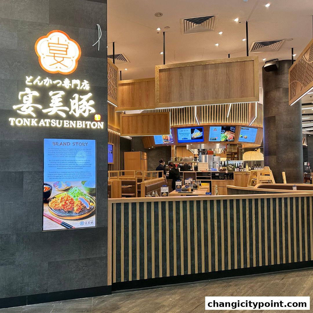 The exterior of Tonkatsu ENbiton restaurant with its logo and brand story displayed.