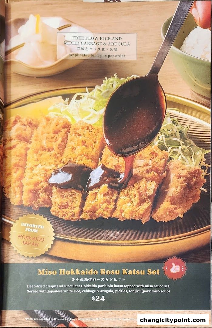 A close-up of a Miso Hokkaido Rosu Katsu Set with sauce being poured.