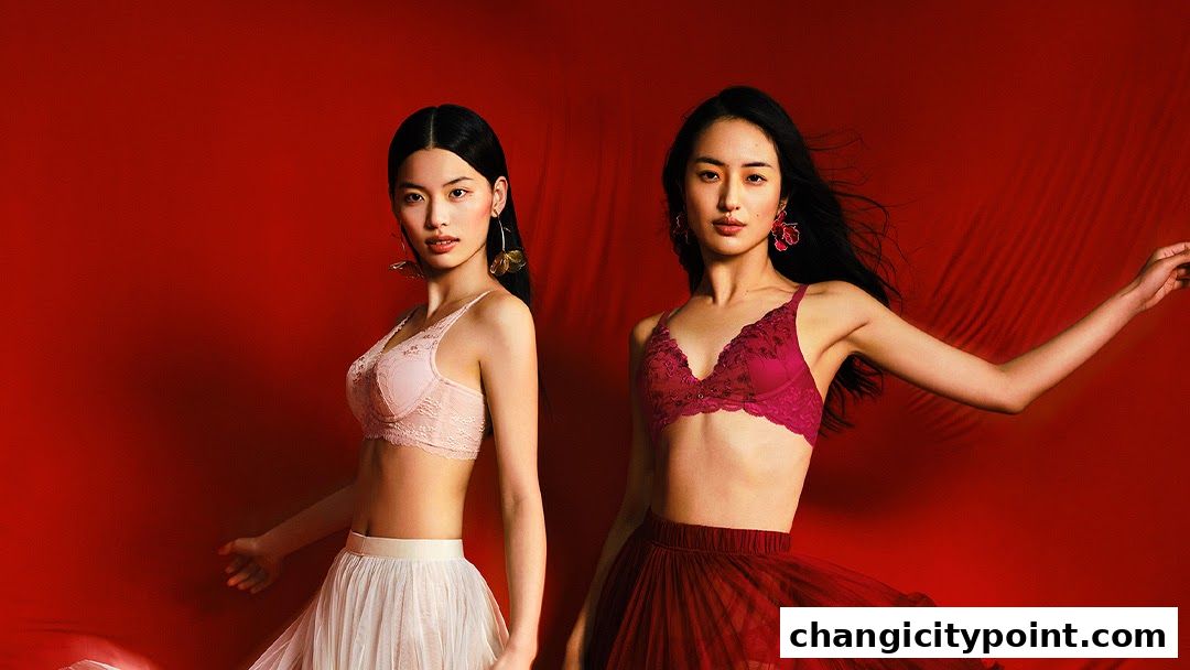 Two models showcase lace bras and flowing skirts against a vibrant red background.