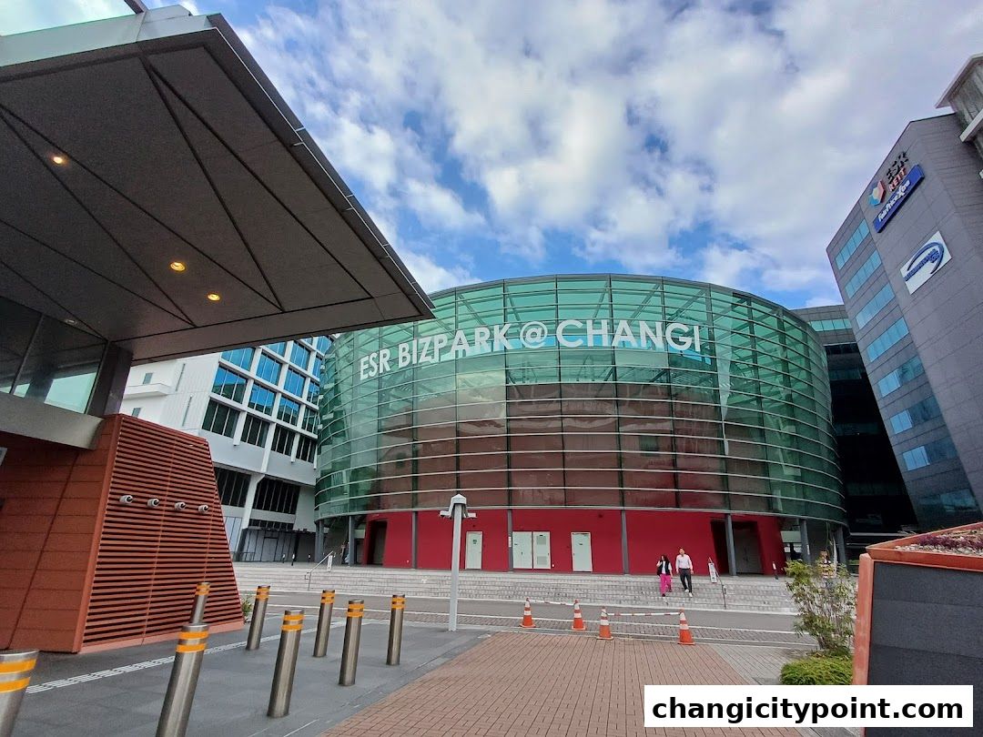 Modern glass building with 'ESR Bizpark@Changi' signage and red accents.