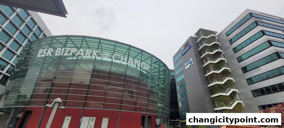 Modern office buildings with glass facades and green vertical gardens.