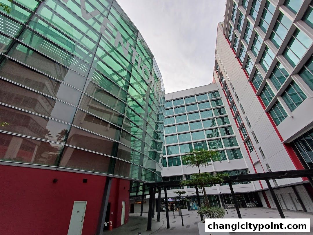 Modern architectural buildings with glass facades and red accents.