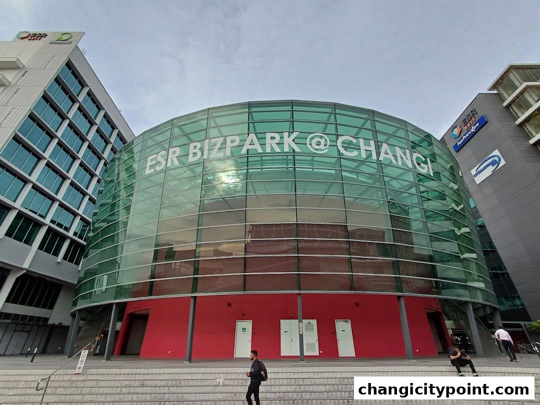 Modern glass building with 'ESR BIZPARK @ CHANGI' signage and red base.