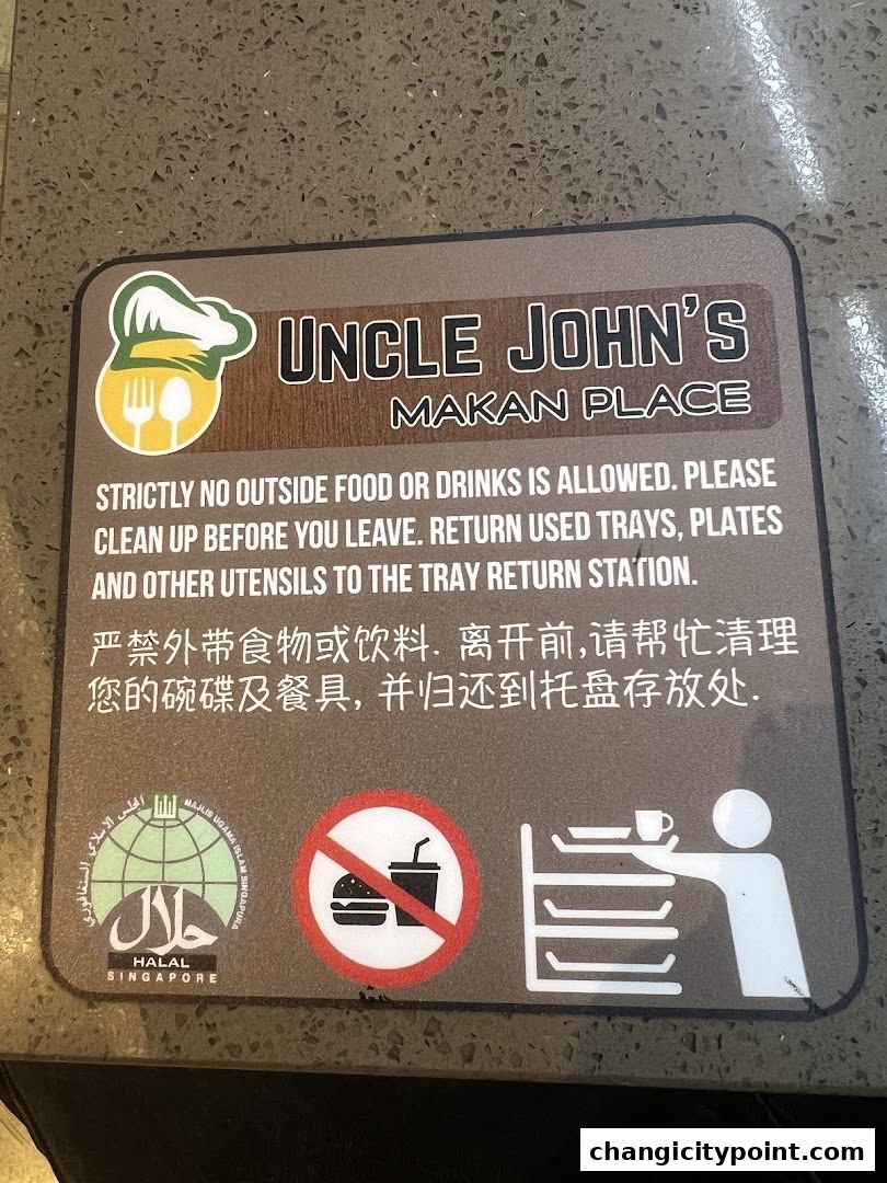 Sign for Uncle John's Makan Place with rules and Halal certification.