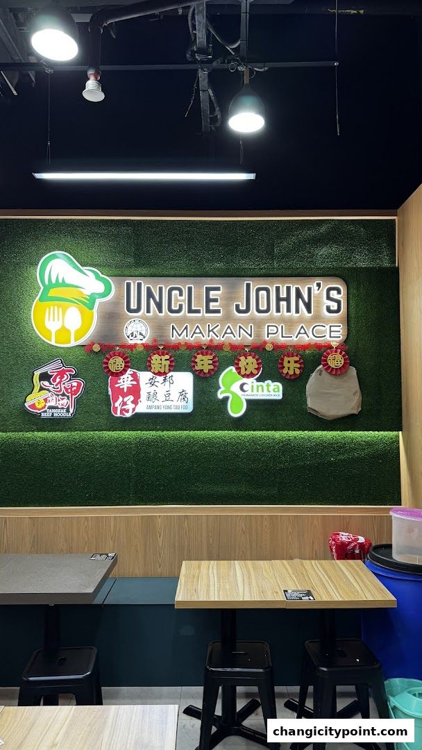 The interior of Uncle John's Makan Place with a prominent sign and seating area.
