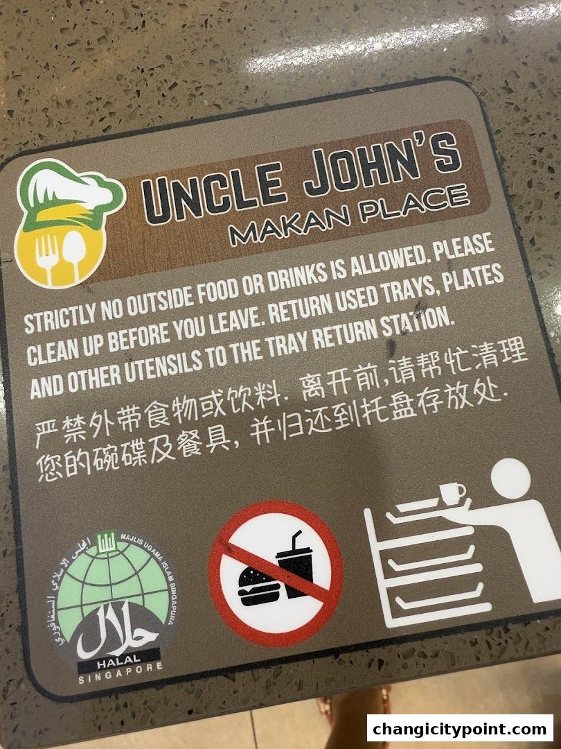 Signage for Uncle John's Makan Place with rules and Halal certification.