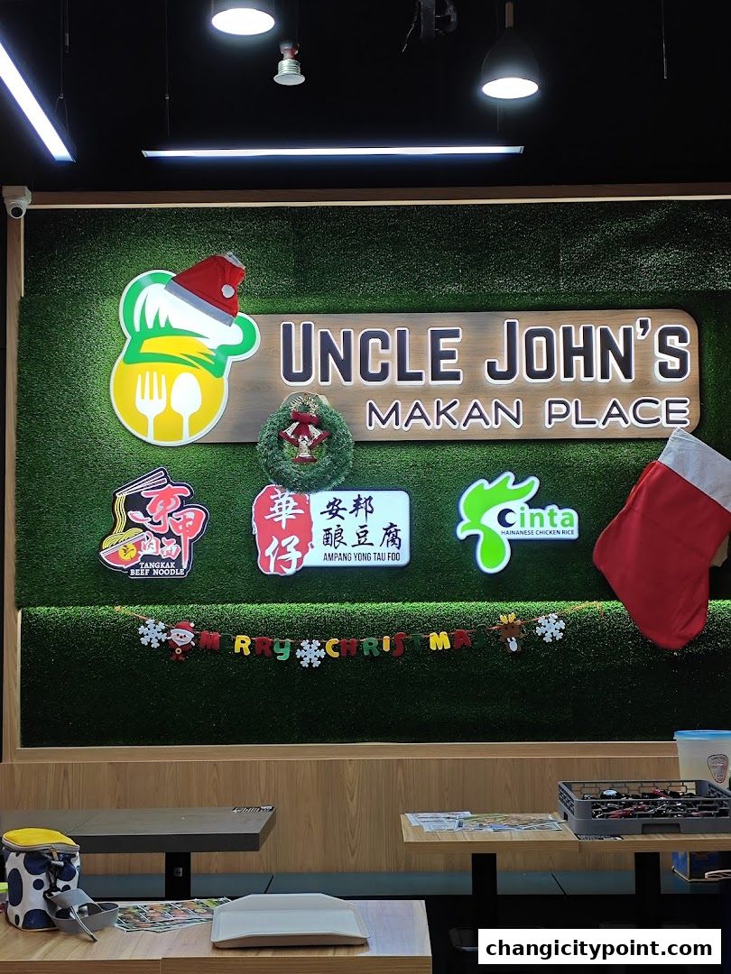 The interior of Uncle John's Makan Place with festive Christmas decorations and menu highlights.