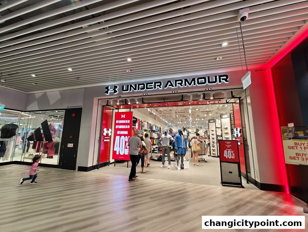 The entrance of an Under Armour store with promotional signage and mannequins displaying apparel.