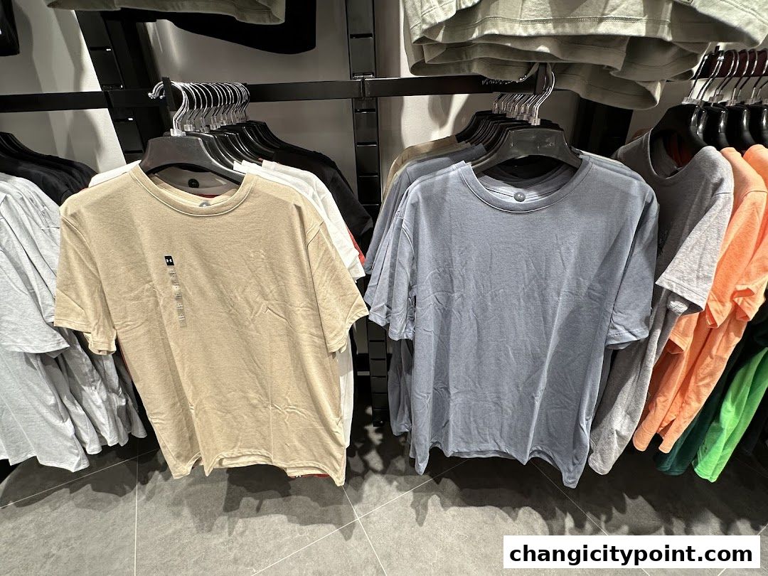 Under Armour t-shirts displayed on hangers in a retail store.