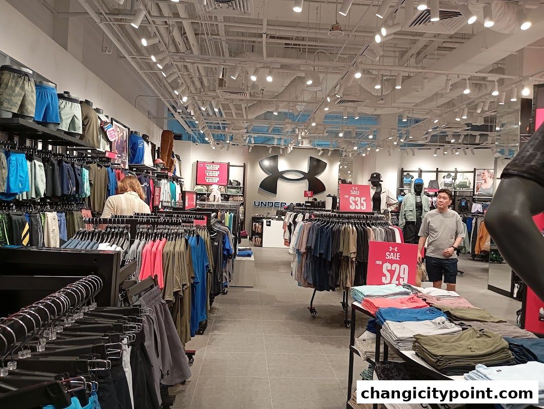 Interior view of an Under Armour store showcasing athletic apparel and sale signs.