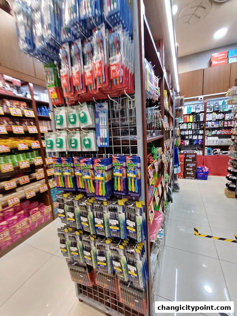 A retail store aisle displaying toothbrushes, dental floss, and other personal care items.