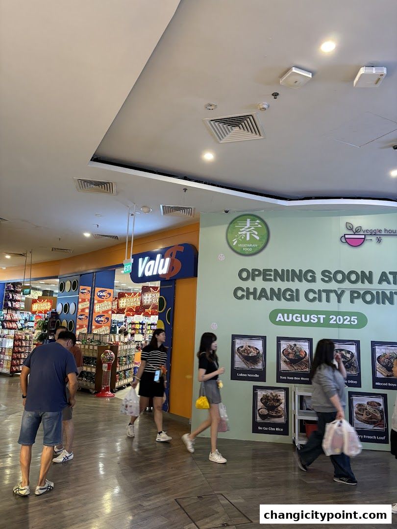A shop front with a sign announcing an upcoming opening at Changi City Point.