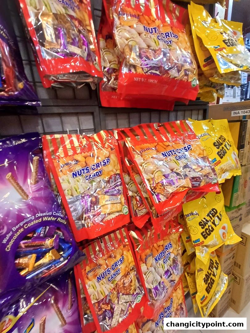 A display of various candy bags, including 'Nuts Crisp Candy' and 'Salted Egg Yolker'.