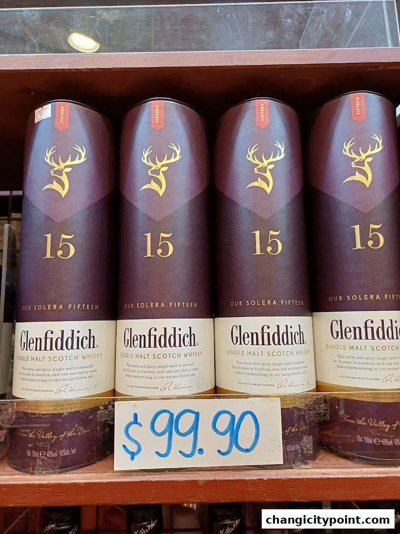 Several bottles of Glenfiddich 15 Year Old single malt Scotch whisky are displayed with a price tag.