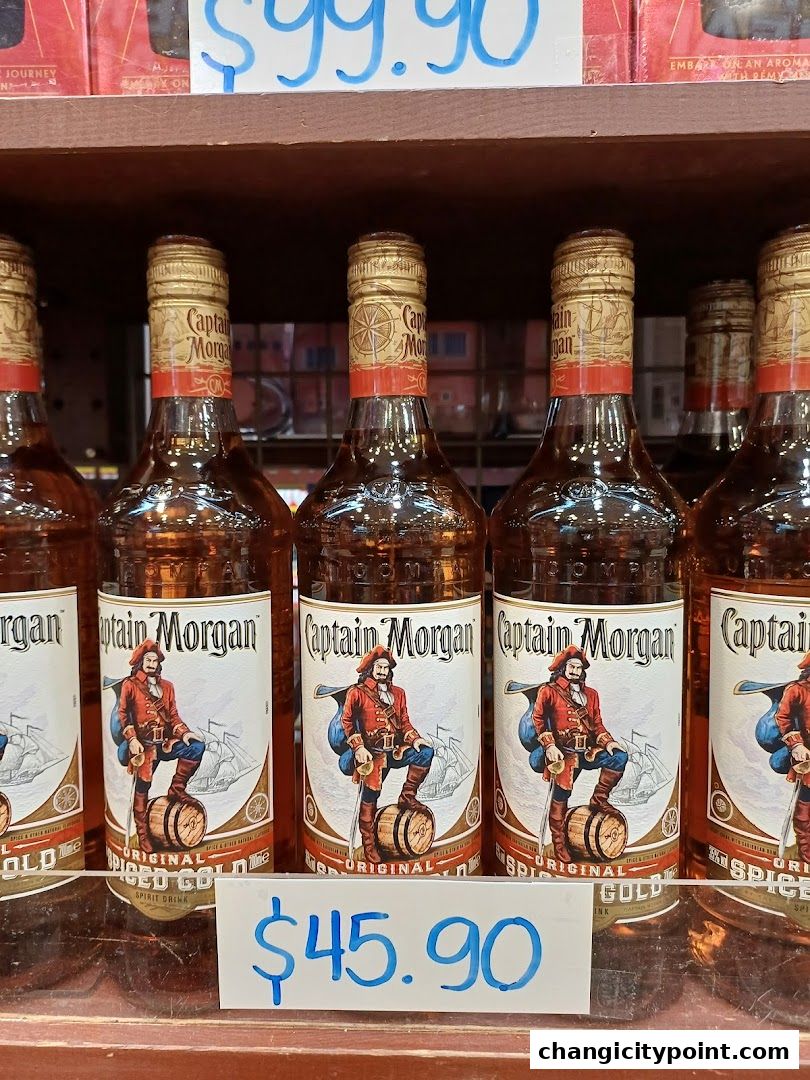 Bottles of Captain Morgan Original Spiced Gold rum displayed on a shelf with price tags.