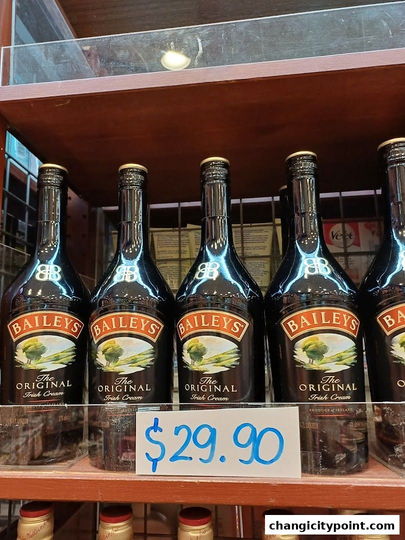Bottles of Baileys Irish Cream liqueur displayed on a shelf with a price tag.