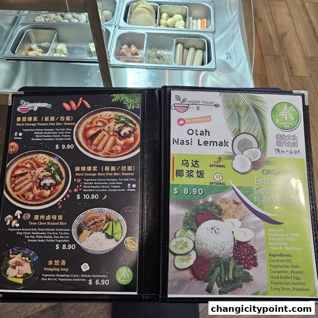 A menu from Veggie House featuring vegetarian dishes like ramen, nasi lemak, and braised rice.