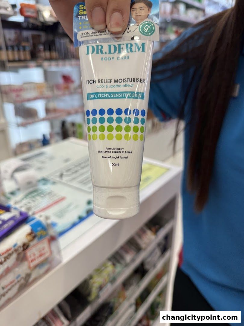 A hand holds a tube of Dr. Derm Itch Relief Moisturiser for dry, itchy, sensitive skin.