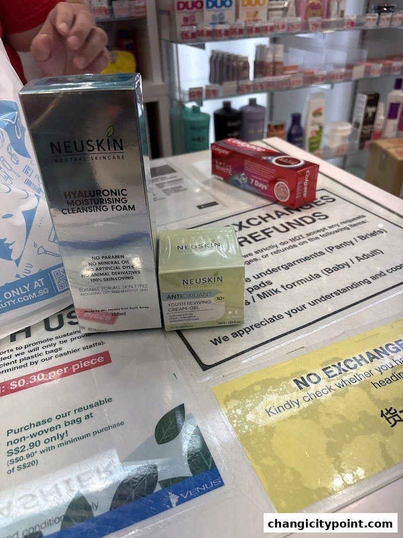 Skincare products from NEUSKIN and toothpaste displayed on a counter with promotional signs.