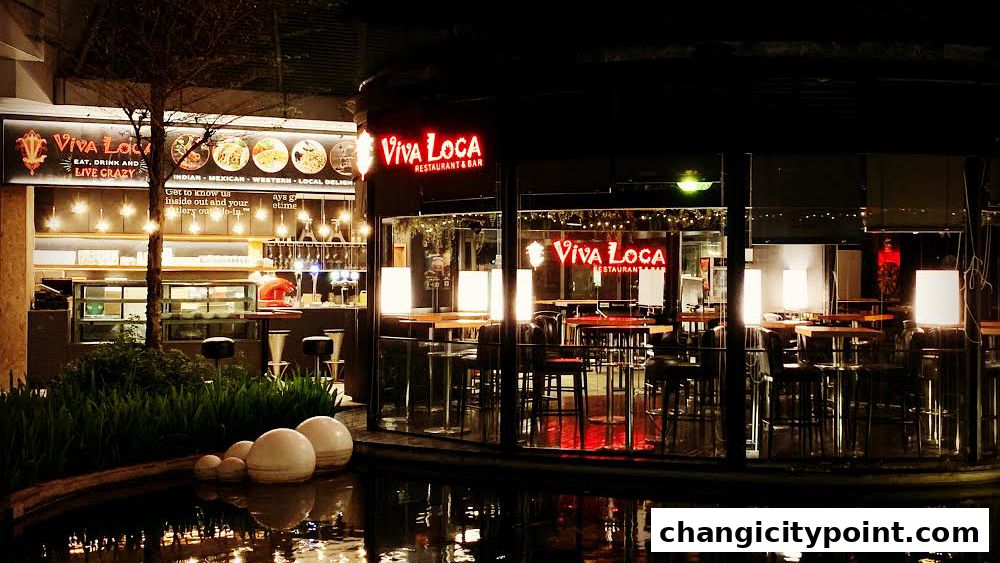 Viva Loca Restaurant & Bar at night, with illuminated signage and interior seating visible.