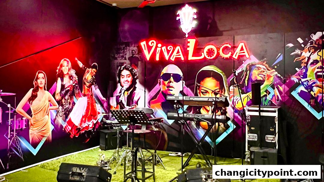 A vibrant mural of musicians and singers adorns the wall behind a stage setup.
