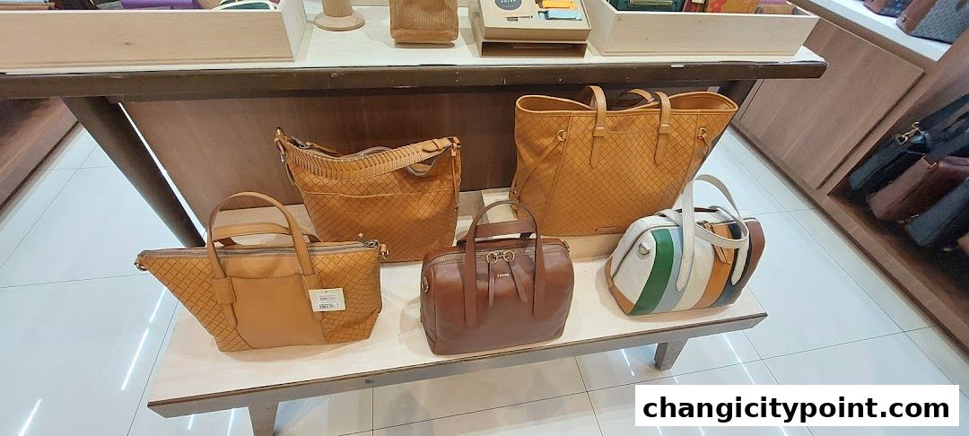 A display of various leather handbags in warm, earthy tones.