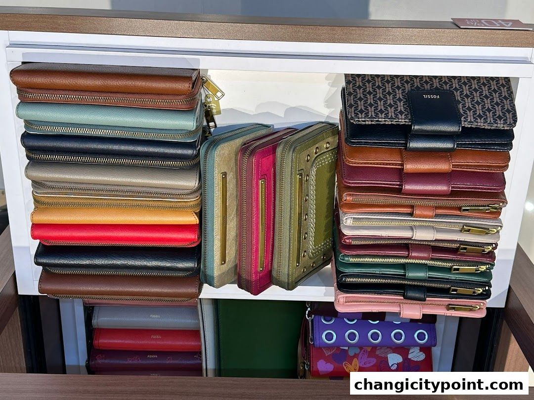 A display of various colorful Fossil wallets stacked neatly on shelves.