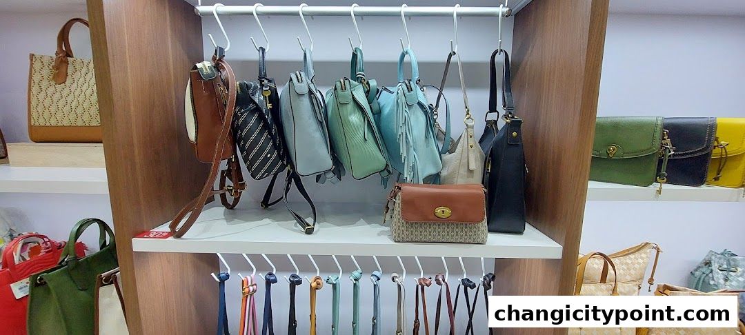 A display of various handbags and purses in different colors and styles.