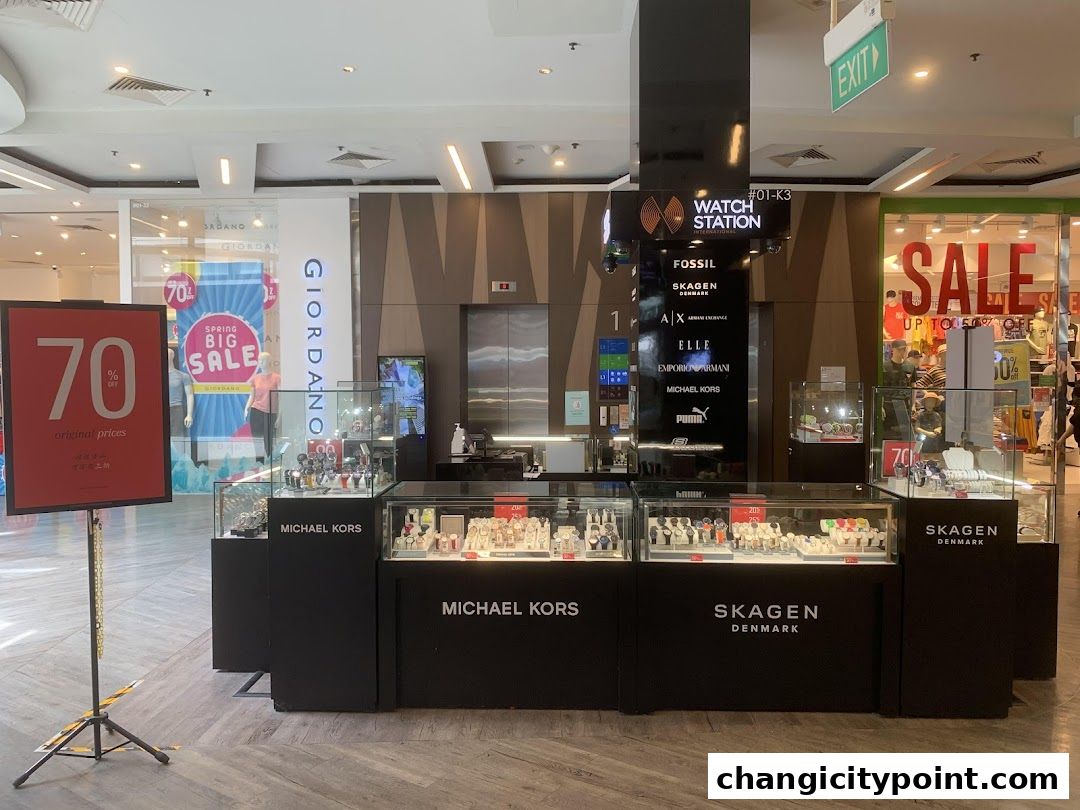 A Watch Station kiosk displaying various watch brands like Fossil, Michael Kors, and Skagen.