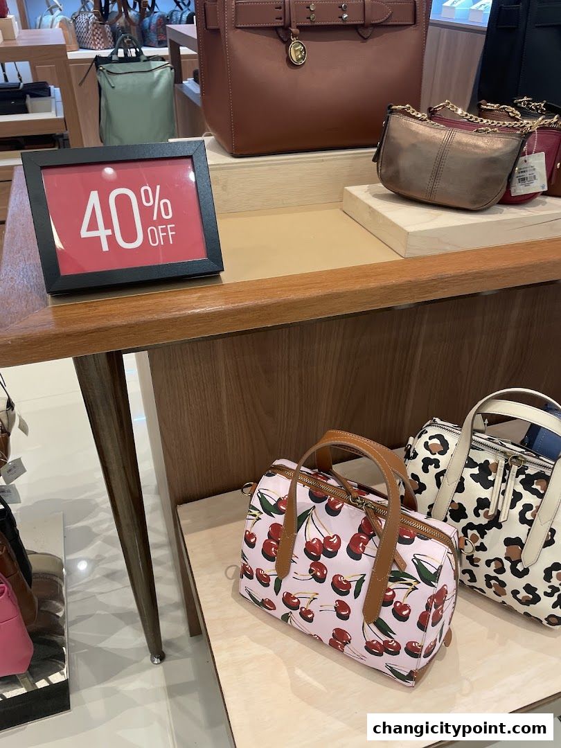 A display of stylish handbags with a '40% OFF' sign.