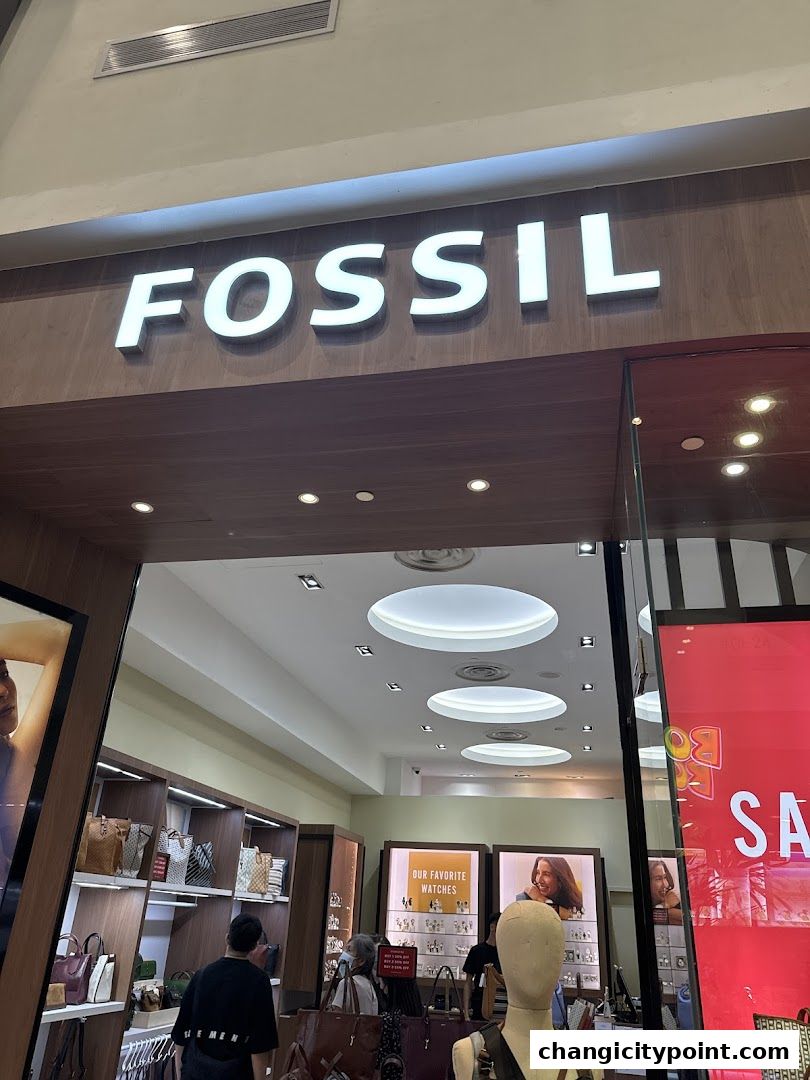 The entrance of a Fossil store displaying watches and handbags.