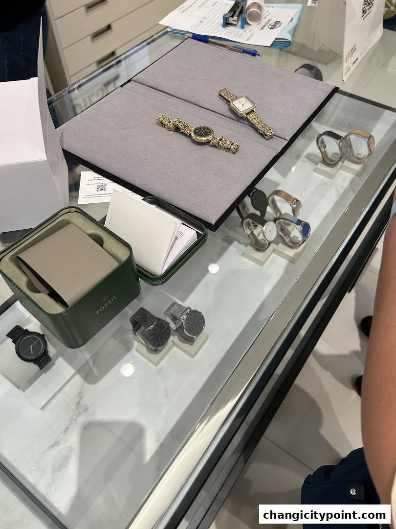 A display of various Fossil watches inside a glass counter at Watch Station.
